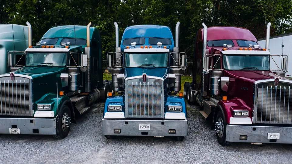 Three semi tractors parked side by side
